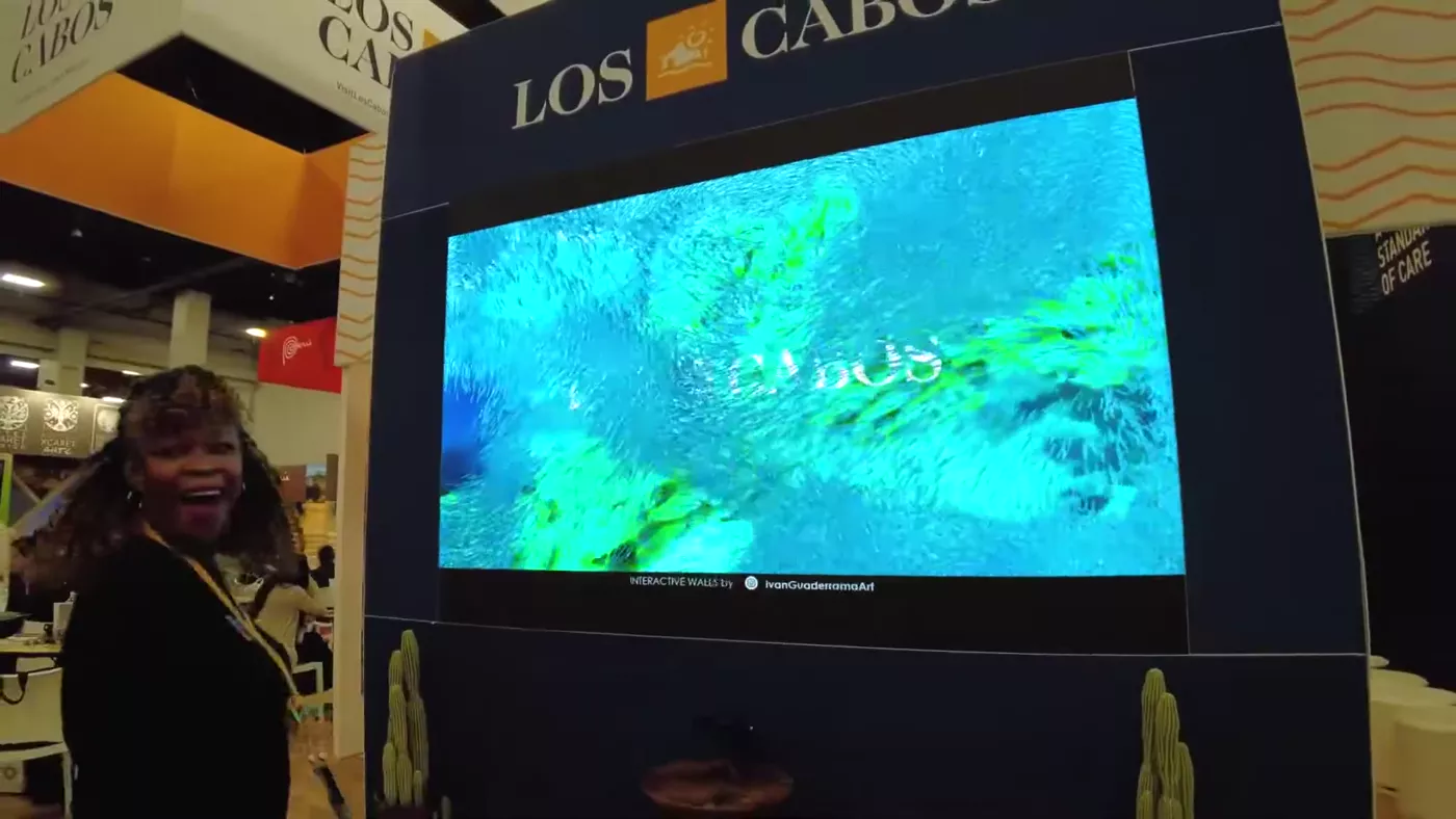 Hand touching underwater scene on LED wall