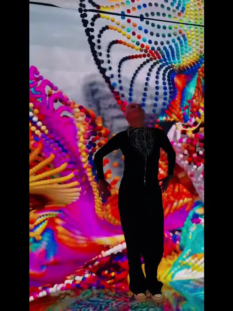 Visitor engulfed in kaleidoscope paint wings
